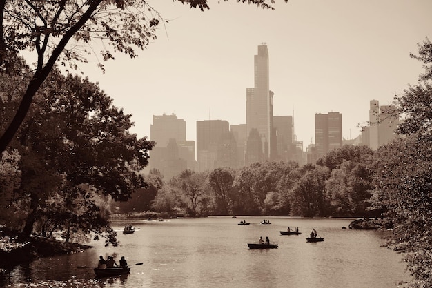 People boating in lake in Central Park in Autumn New York City