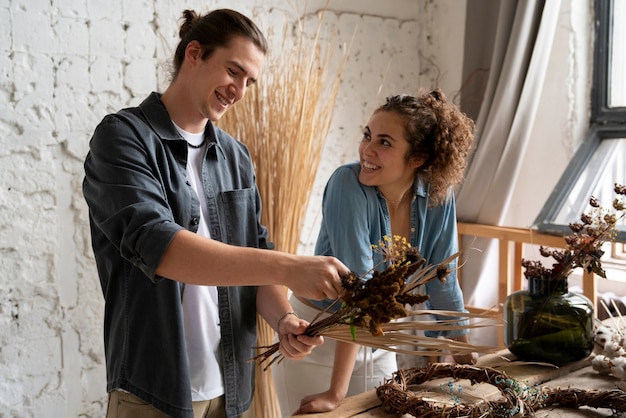 Free photo people building their own dried arrangement