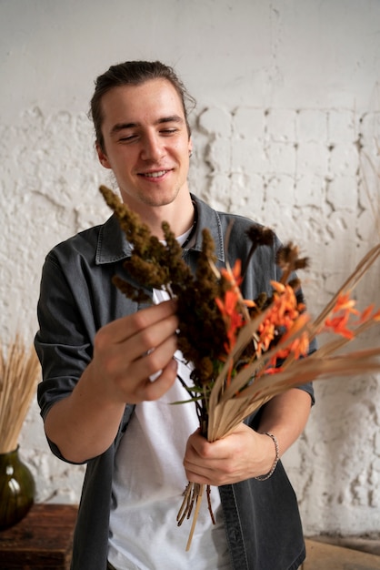 Free photo people building their own dried arrangement