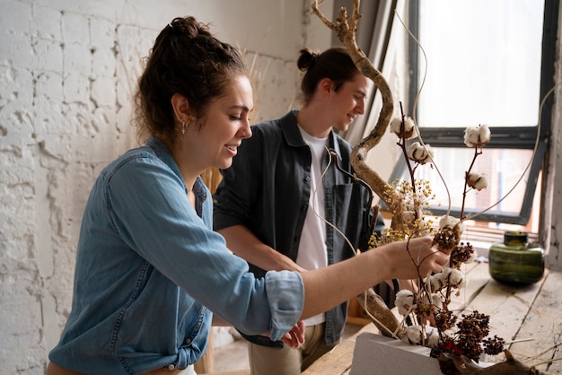 Free photo people building their own dried arrangement