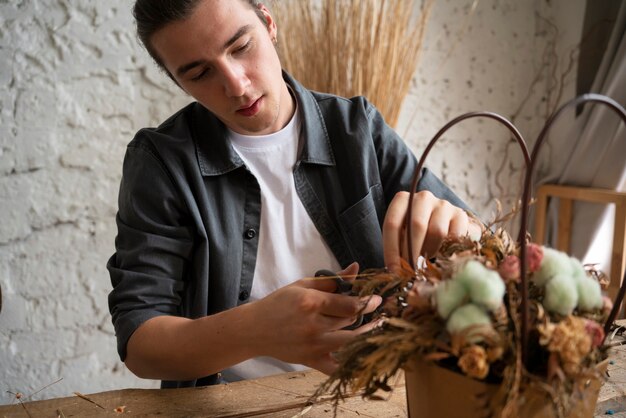 Free photo people building their own dried arrangement