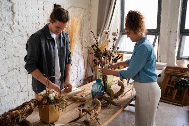 Free photo people building their own dried arrangement