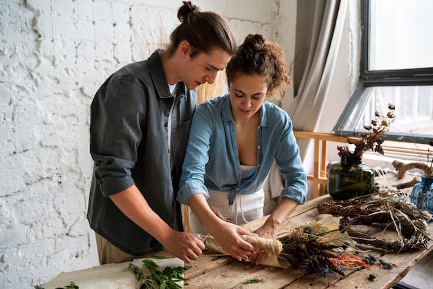 Free photo people building their own dried arrangement