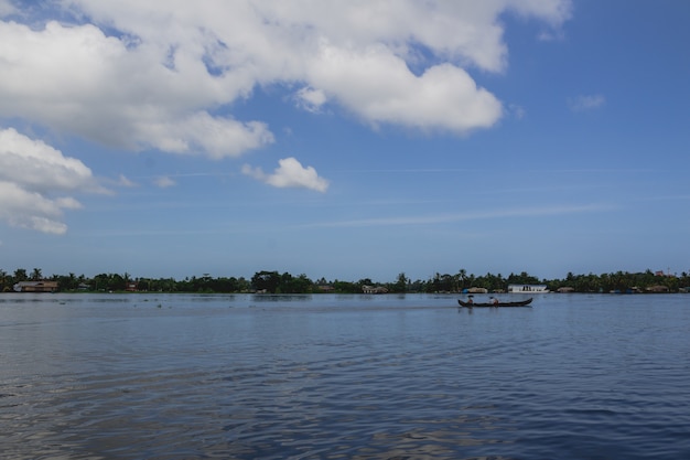 People in a canoe on a river with umbrellas