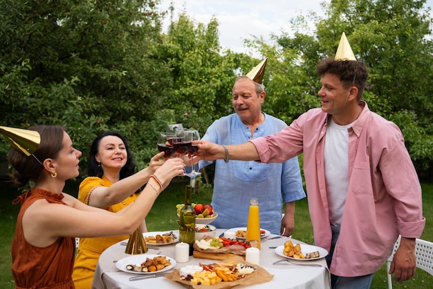 People celebrating a senior birthday party outdoors in the garden