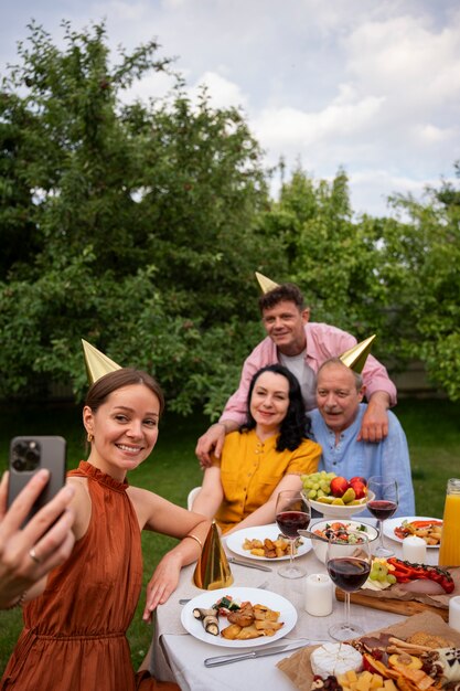 People celebrating a senior birthday party outdoors in the garden