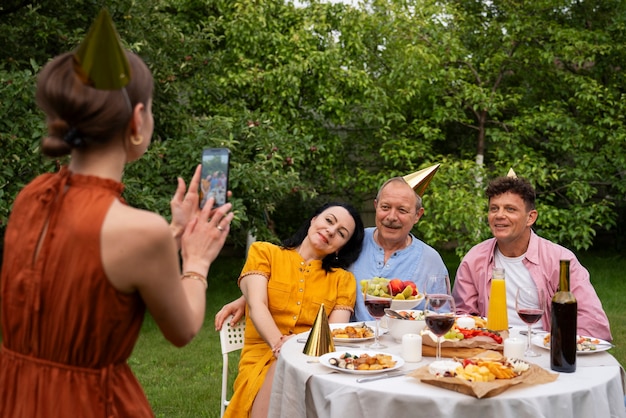 People celebrating a senior birthday party outdoors in the garden