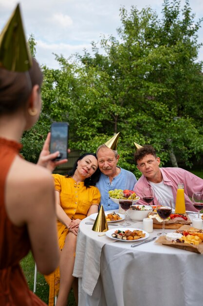 People celebrating a senior birthday party outdoors in the garden