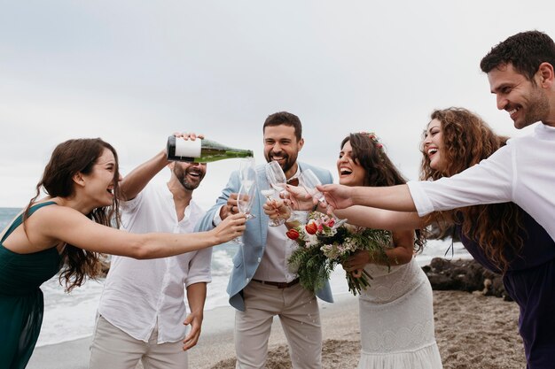 People celebrating with their friends getting married on the beach