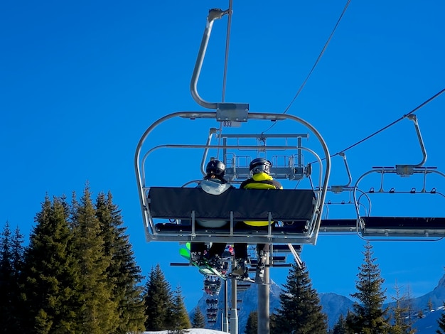 People on chair lift in french alps, Europe