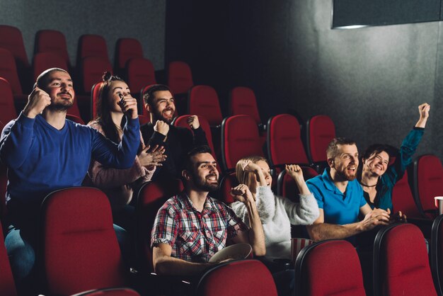 People cheering in cinema auditorium