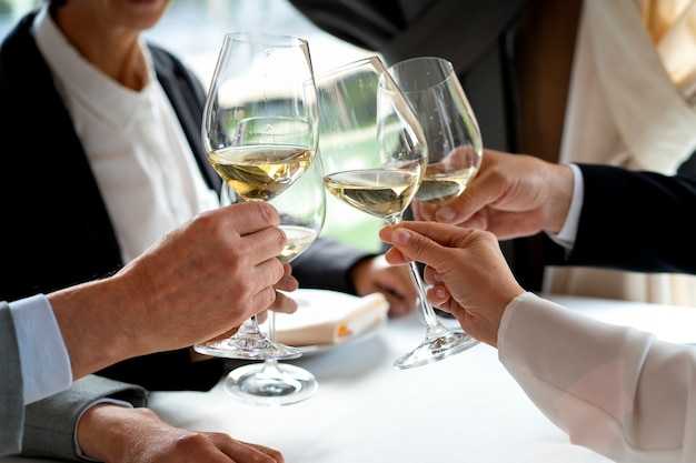 People cheering with wine glasses at a luxurious restaurant