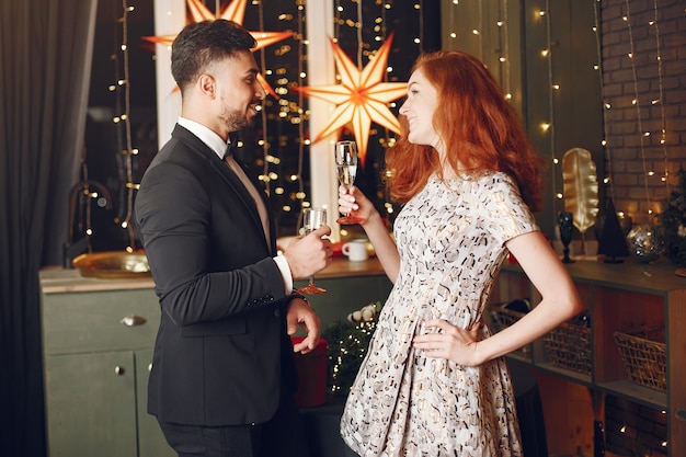 People in a Christman decorations. Man in a black suit.