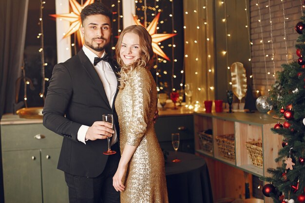 People in a Christman decorations. Man in a black suit.