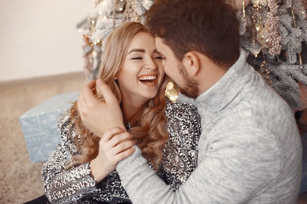 People in a Christmas decorations. Man in a gray sweater. Family at home.