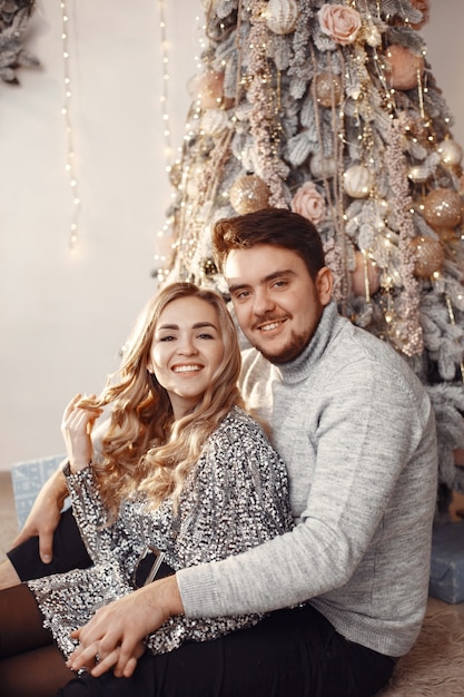 People in a Christmas decorations. Man in a gray sweater. Family at home.