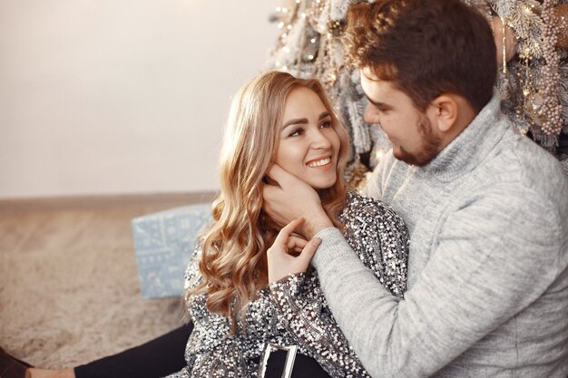 People in a Christmas decorations. Man in a gray sweater. Family at home.