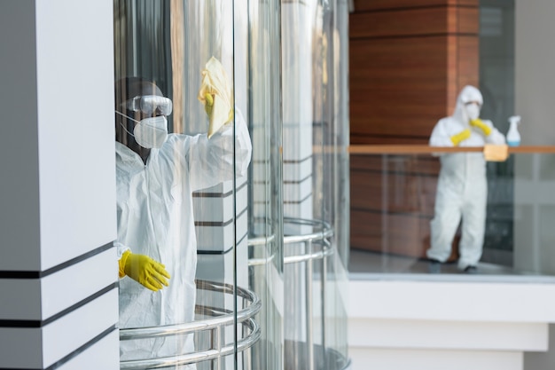 People cleaning in hazmat suits