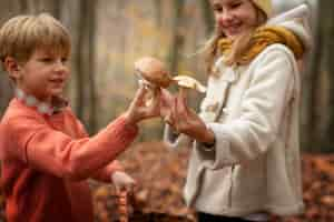 Free photo people collecting food from the forest