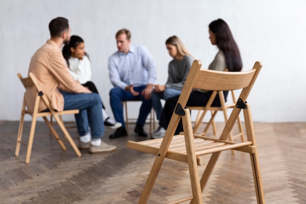 People conversing at a group therapy session