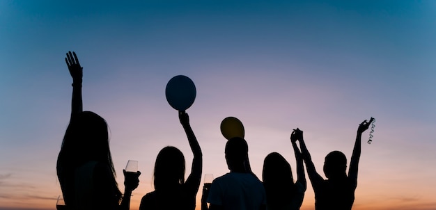 Free photo people dancing at rooftop party in the dawn