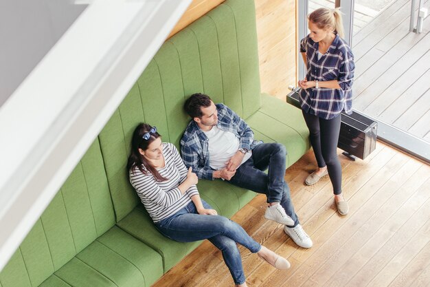 People discussing on sofa