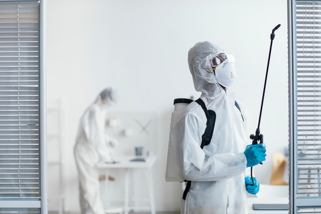 people disinfecting together a dangerous area