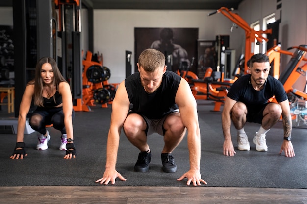 Free photo people doing burpees together full shot