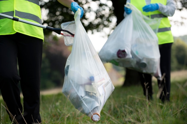 People doing community service by collecting trash outdoors