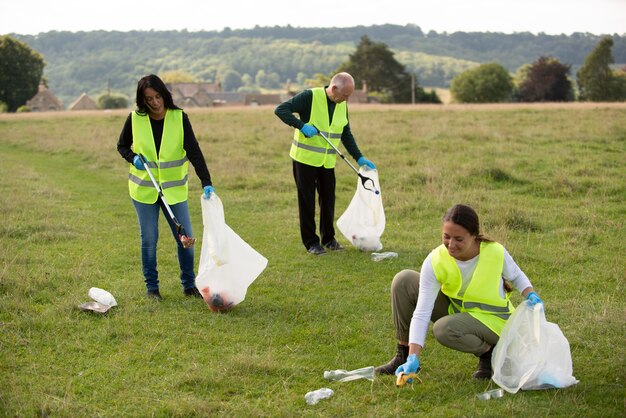 People doing community service by collecting trash outdoors