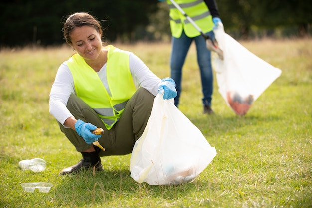 People doing community service by collecting trash outdoors