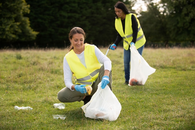 Free photo people doing community service by collecting trash