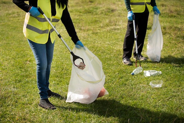 Free photo people doing community service by collecting trash