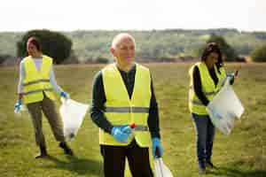 Free photo people doing community service by collecting trash