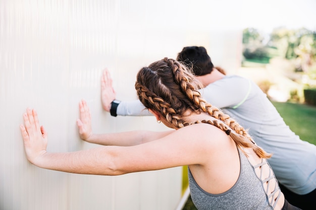 People doing exercises near wall