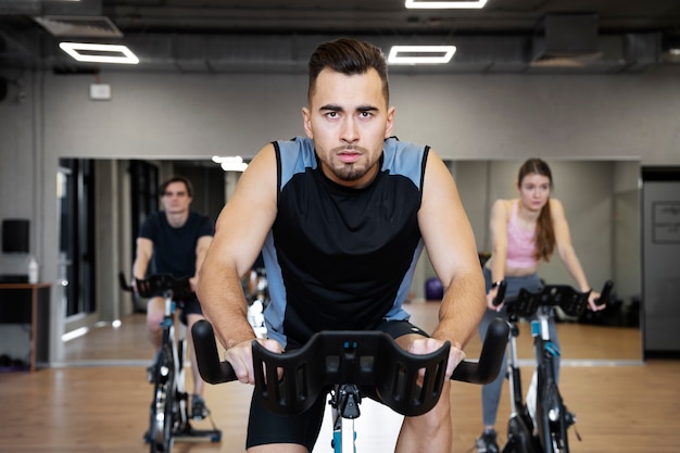 Free photo people doing indoor cycling