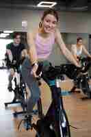 Free photo people doing indoor cycling