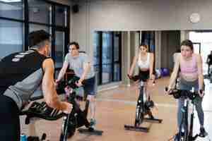 Free photo people doing indoor cycling