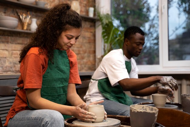 People doing pottery side view