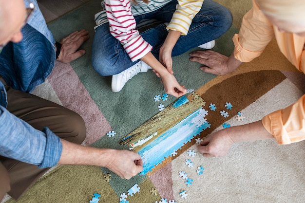 People doing puzzle on floor close up