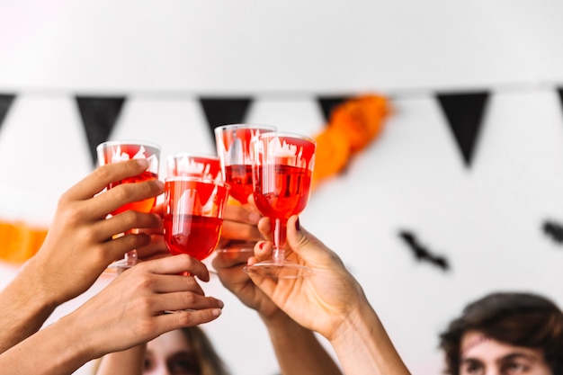 Free photo people drink from glasses with painted blood