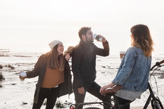 People drinking coffee on seashore