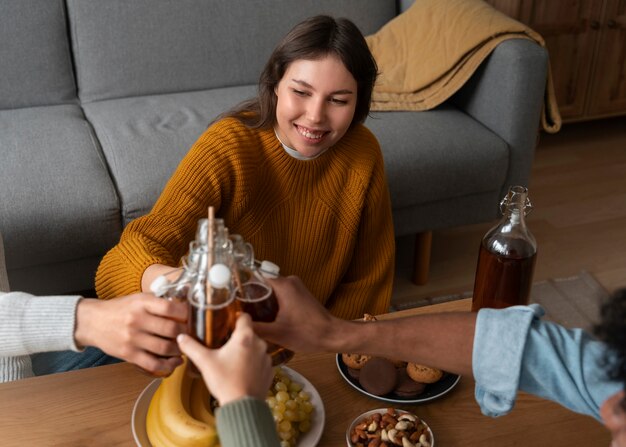 Free photo people drinking kombucha at a gathering