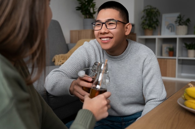 Free photo people drinking kombucha at a gathering