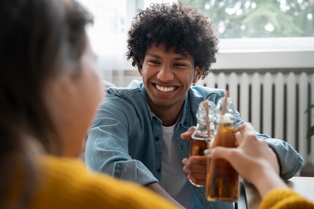 Free photo people drinking kombucha at a gathering