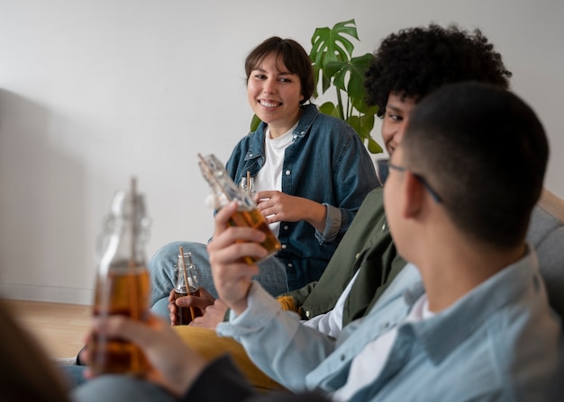 Free photo people drinking kombucha at a gathering