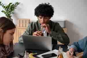 Free photo people drinking kombucha at a gathering