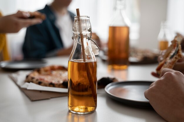 Free photo people drinking kombucha at a gathering