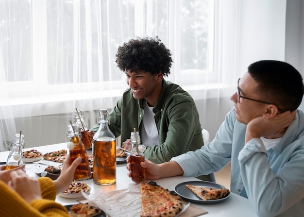 Free photo people drinking kombucha at a gathering