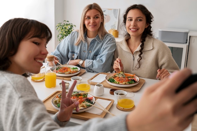 Free photo people eating delicious salmon bowl